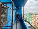 Balcony with blue painted walls and a view of neighboring buildings