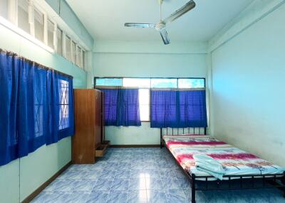 Simple bedroom with blue curtains and a single bed