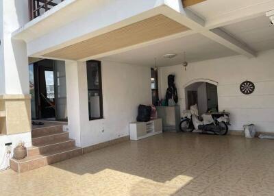 Covered open area with tiled flooring and motorcycle