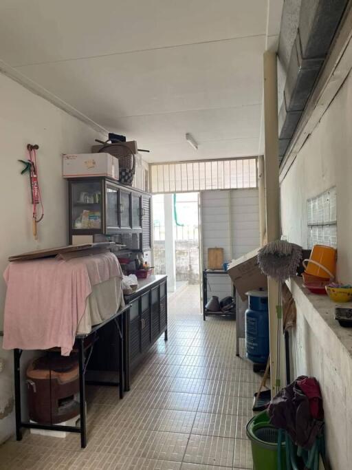 Laundry area with various cleaning supplies and appliances