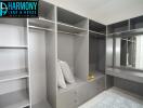 Spacious walk-in closet with built-in shelves and a vanity area