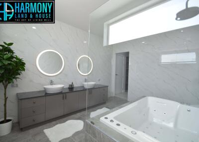 Modern bathroom with double sinks and jacuzzi