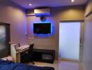 Modern bedroom with work area and wall-mounted TV