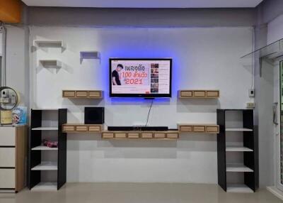 Modern living room entertainment wall with mounted TV and shelves