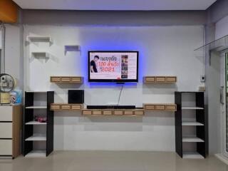 Modern living room entertainment wall with mounted TV and shelves