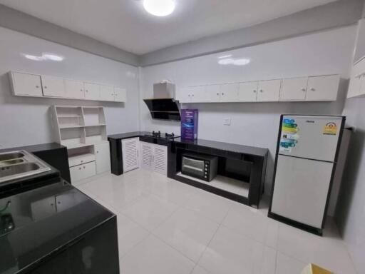 Modern kitchen with white cabinetry and appliances