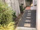 Pathway in backyard with stepping stones and surrounding plants