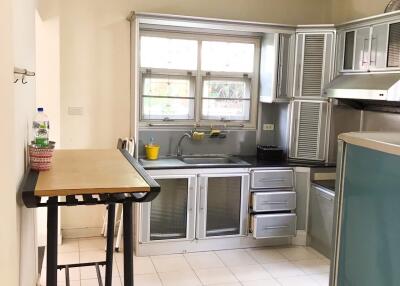 Modern kitchen with table and large windows