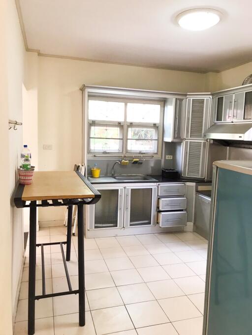 Modern kitchen with table and large windows