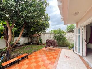 Spacious backyard with tiled patio and mature trees