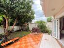 Spacious backyard with tiled patio and mature trees