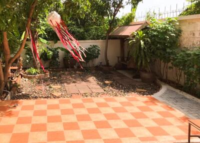 Well-maintained backyard with tiled floor and garden