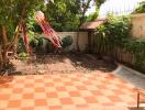 Well-maintained backyard with tiled floor and garden