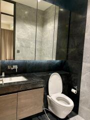 Modern bathroom with marble accents and vanity mirror