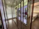 A sleek bedroom with a large mirrored wardrobe