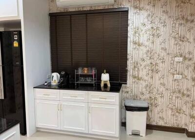 Modern kitchen with white cabinetry and appliances