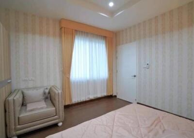 Modern bedroom with armchair and window