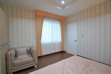 Modern bedroom with armchair and window