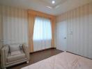 Modern bedroom with armchair and window