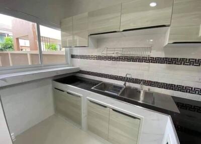 Modern kitchen with cabinets and large window