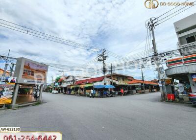 Street view of a neighborhood with shops and utility poles