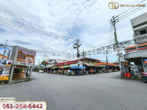 Street view of a neighborhood with shops and utility poles