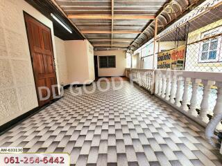 Covered outdoor hallway with tiled floor