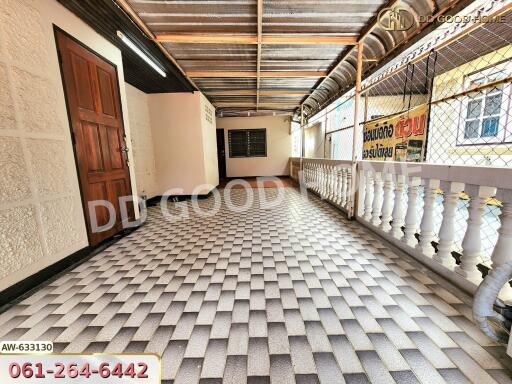 Covered outdoor hallway with tiled floor