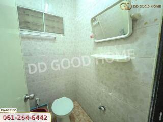 Bathroom with basic amenities and tiled walls