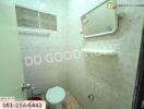 Bathroom with basic amenities and tiled walls