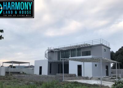 Modern two-story house with large windows and a flat roof