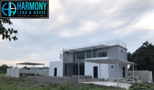 Modern two-story house with large windows and a flat roof