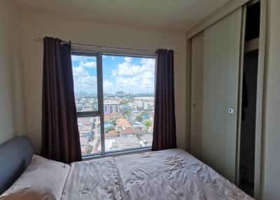 Bedroom with a view of the city through a large window