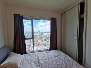 Bedroom with a view of the city through a large window