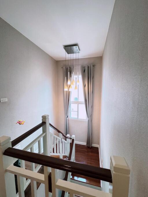 A modern staircase with natural lighting from a window