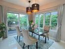 modern dining room with glass table and beige chairs