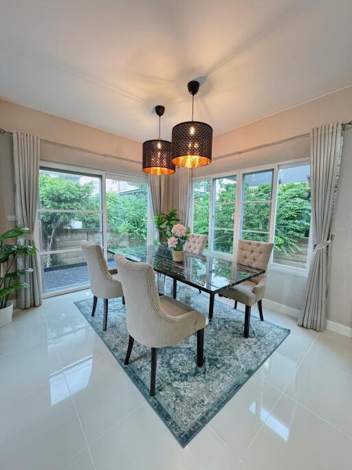 modern dining room with glass table and beige chairs