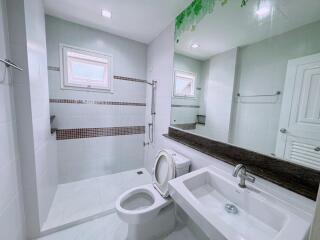 Modern bathroom with shower, toilet, and sink