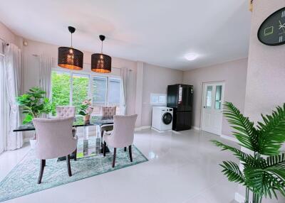 Modern dining area with glass table and upholstered chairs