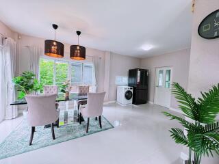 Modern dining area with glass table and upholstered chairs