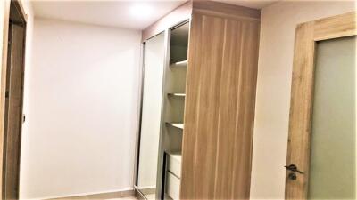 Modern bedroom with sliding wardrobe and wooden door