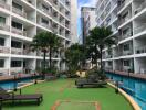 Outdoor common area with pool and lounge chairs