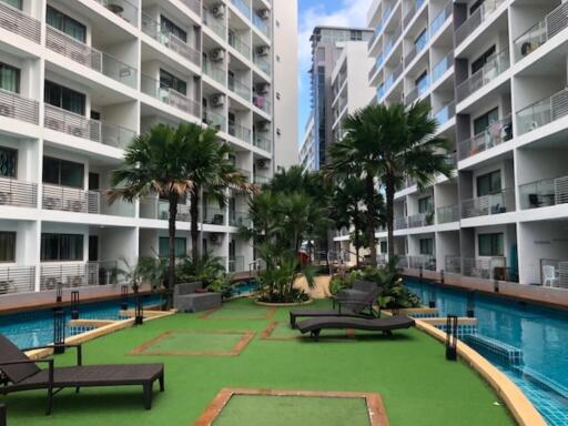 Outdoor common area with pool and lounge chairs