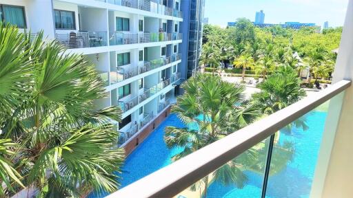 Balcony view overlooking pool and apartment building