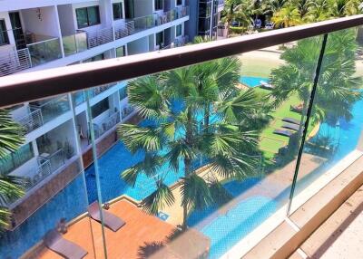 Balcony view with pool and palm trees