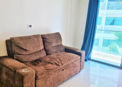 Living room with a brown sofa and sliding glass door