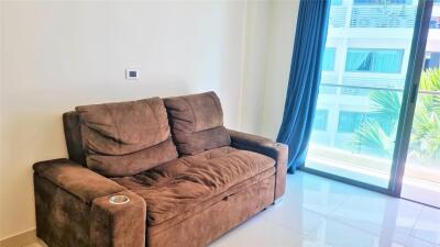 Living room with a brown sofa and sliding glass door