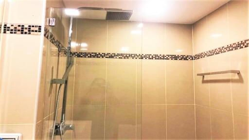 Modern tiled shower with rain showerhead