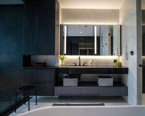 Modern bathroom with large mirror and black cabinetry