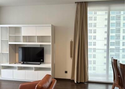 Modern living room with leather seating and entertainment center